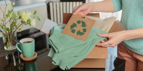 Woman,Packing,Box,With,Used,Wardrobe,And,Card,With,Circular